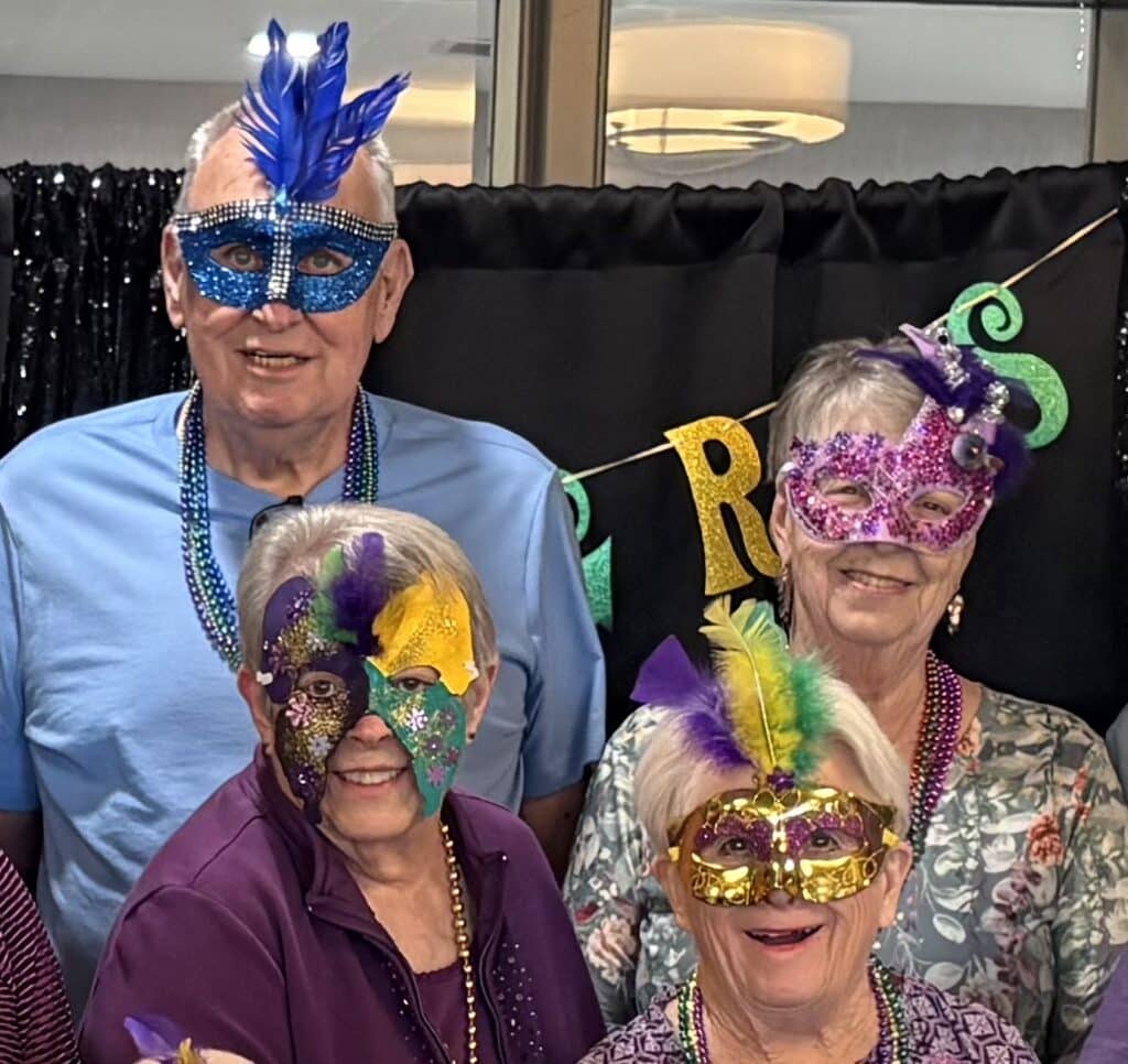 Residents gathered in Mardi Gras masks and beads at Villas at Stoney Point, celebrating Fat Tuesday with handmade masks and themed activities.