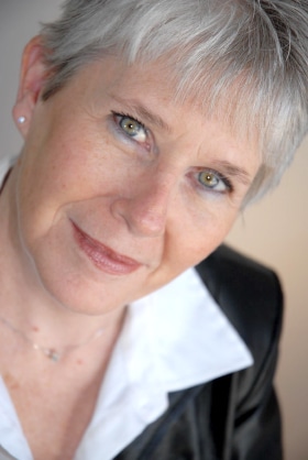 Close-up portrait of an adult in indoor setting with natural light, representing a welcoming senior living lifestyle like Villas at Stoney Point